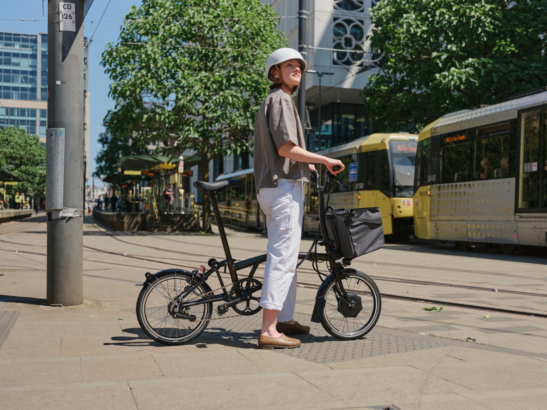 Person stood with Brompton Electric C Line bike