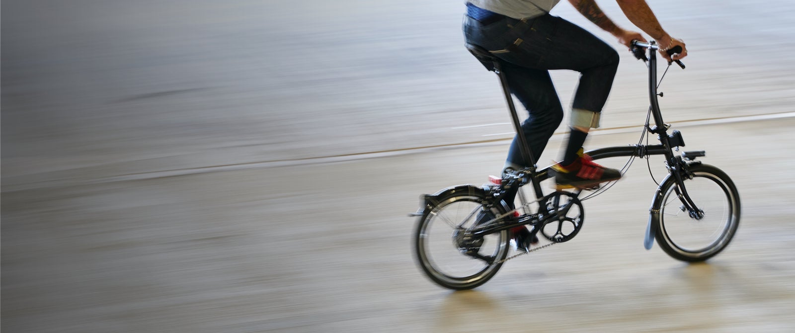 A person riding a Brompton P Line quickly