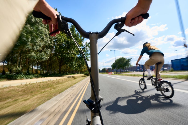 gros plan d'une personne à vélo sur un vélo de la marque Brompton