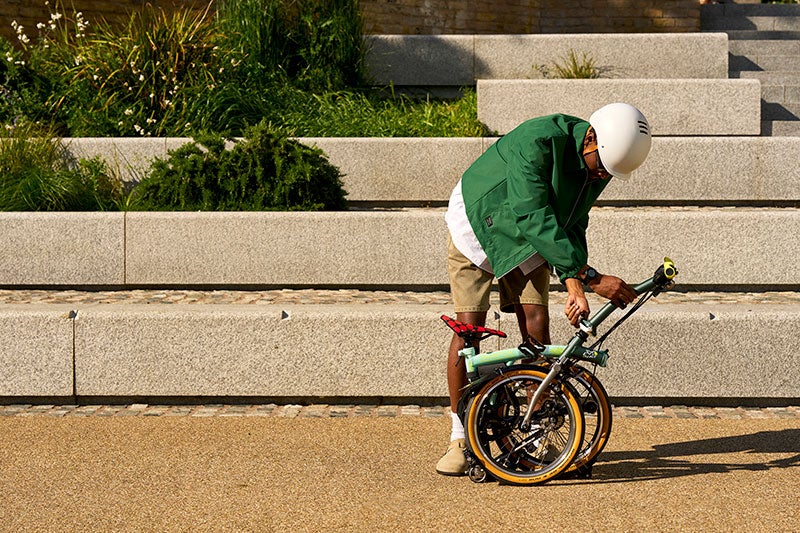 Person folding a Brompton x Tour de France bike