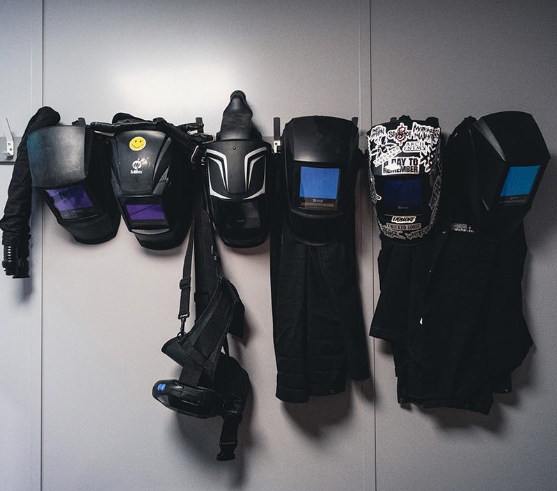 welding helmets hanging on a wall