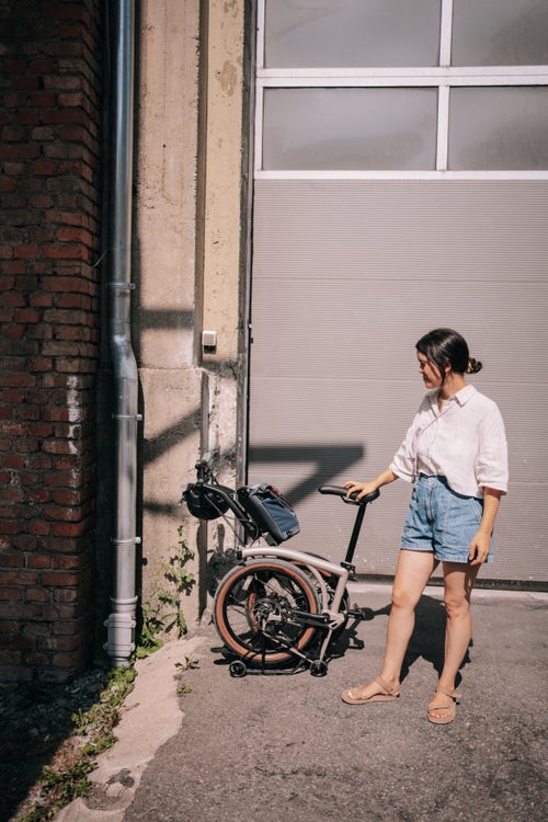 woman stood with brompton g line bike