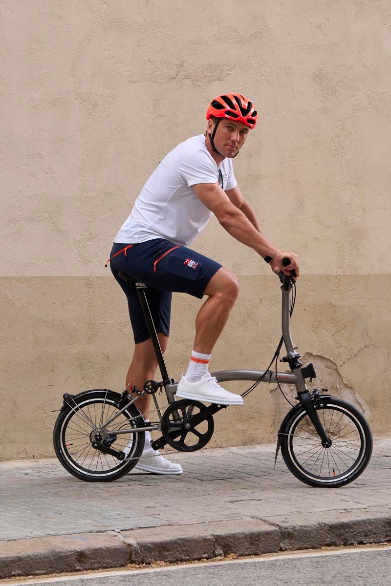 Ben Cornish cycling on a Brompton folding bike for the INEOS partnership
