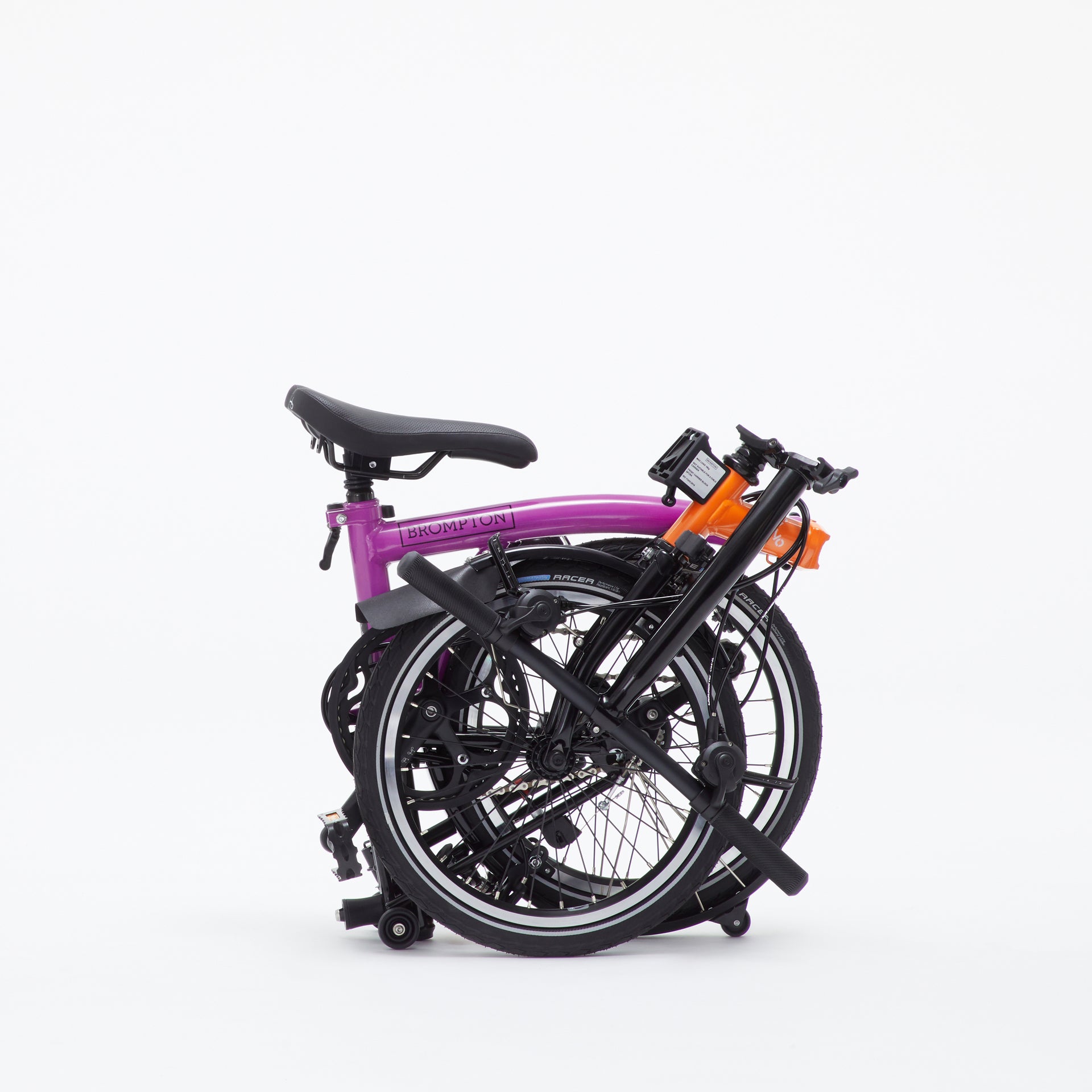 A folded purple and orange Kenzo x Brompton bike