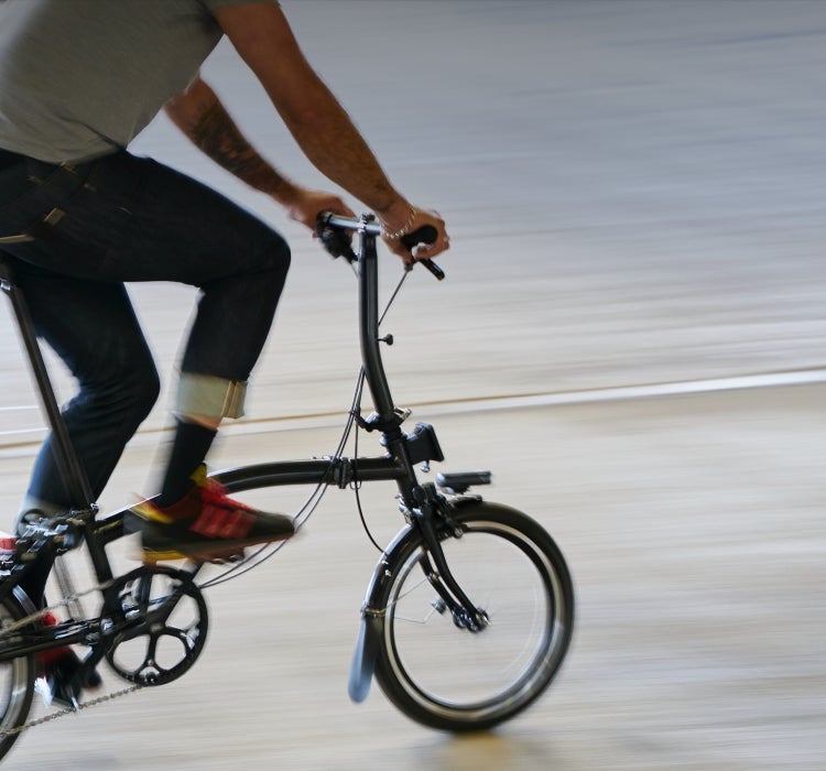 A person riding a Brompton P Line quickly
