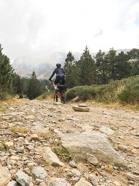 Person riding Brompton G Line bike on gravel path