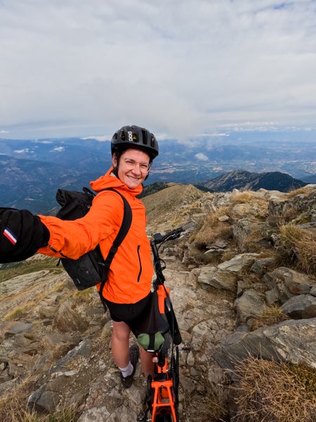 Sophie with the Brompton G Line bike on top a mountain