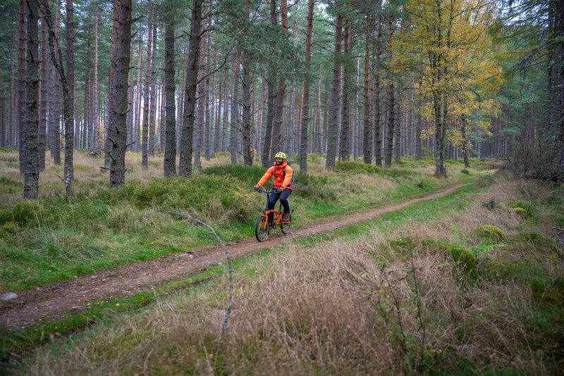 Personne roulant sur un vélo Brompton G Line sur un chemin de gravier