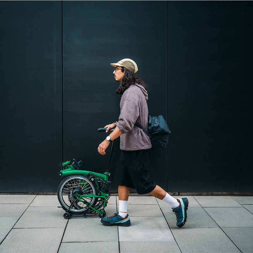 Man pushes Brompton Electric C Line in SuperRoll+ mode.