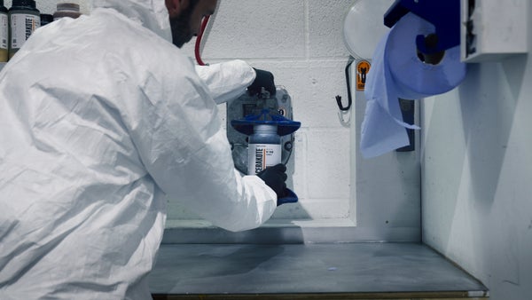 Person spaying Brompton bike frame