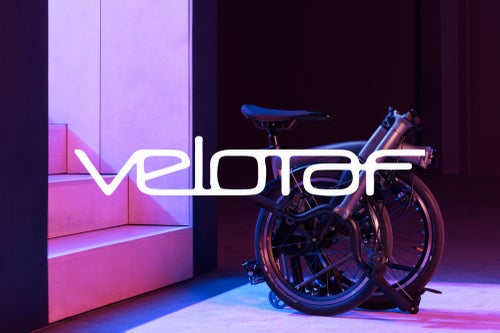 Vélotaf logo over image of a folded Brompton T Line