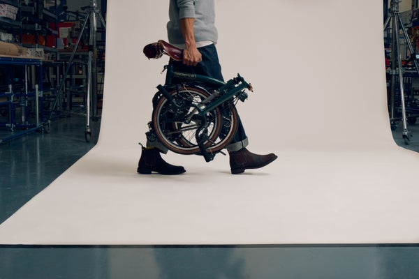 Personne transportant un vélo Brompton x Bremont x Cheaney