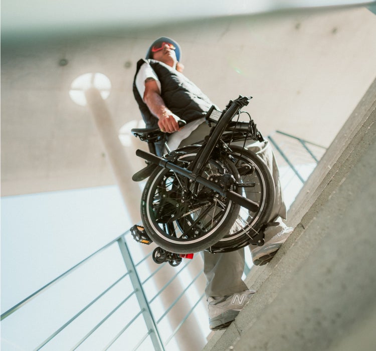 A dual-image edit of a man carrying a P Line downstairs, and it folded back up the stairs