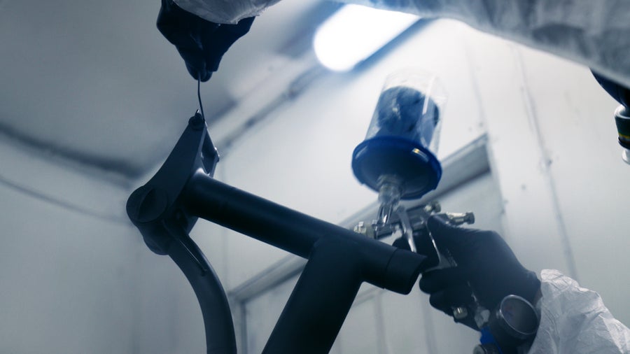 Person spraying a Brompton bike frame