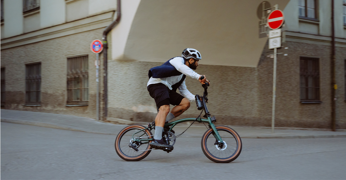 Person riding G Line around a corner in a city